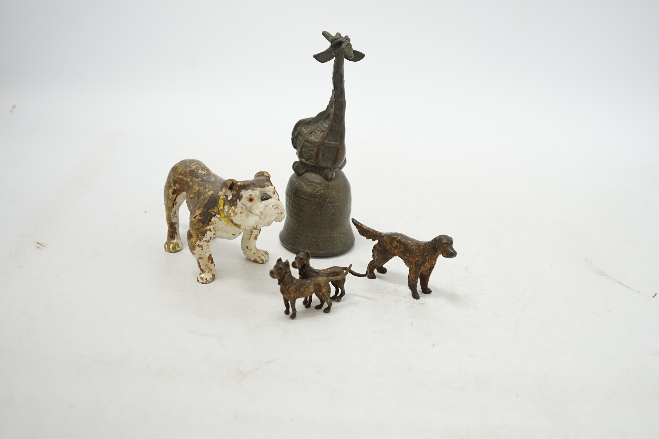 Three cold painted bronze dogs and a bronze giraffe handled bell, bell 13.5cm high. Condition - fair
